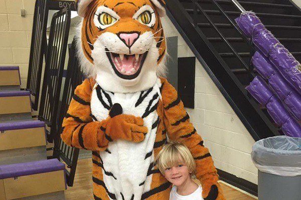 Child posing with tiger mascot