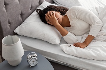 Exhausted woman lying in bed