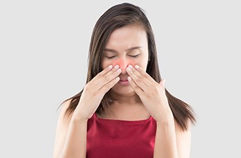 Woman suffering from nasal congestion