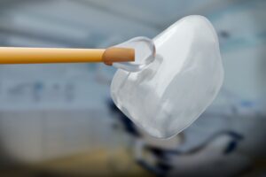 Closeup of glue being applied to veneer