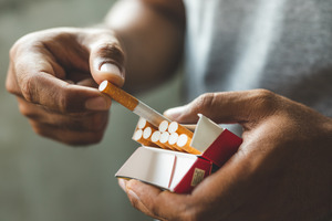 Taking a cigarette out of a box