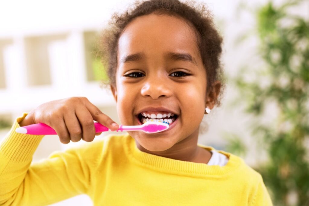 A little girl brushing her teeth